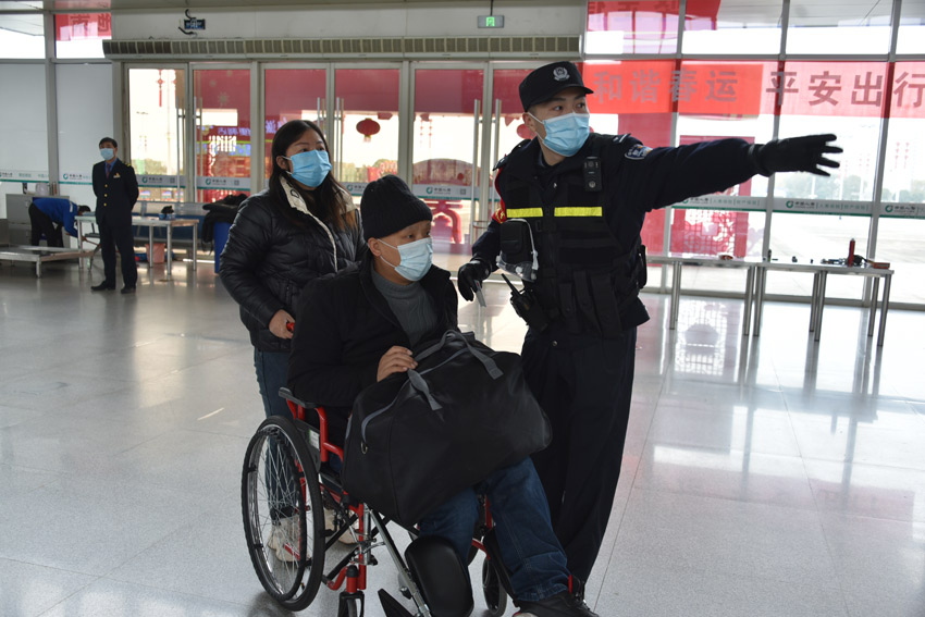 高安站鐵路民警引導重點旅客乘車。（邱玲 攝）