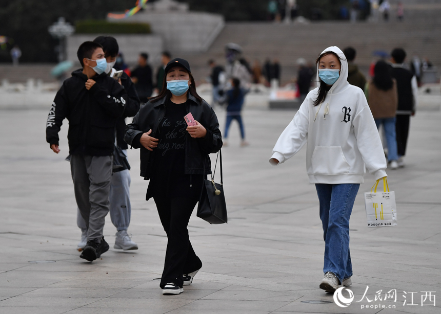 国庆假期后期，江西气温骤降，市民和游客着秋装出行。 人民网 时雨摄