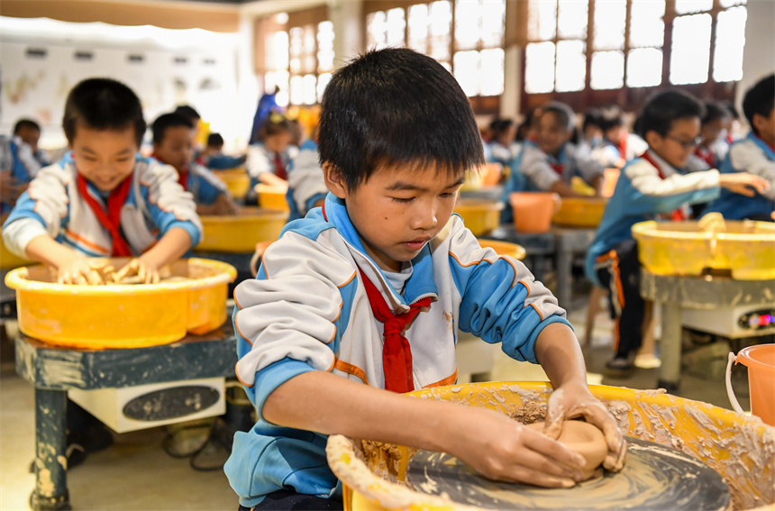 樟樹市臨江鎮中心小學的學生在臨江古府研學基地體驗陶瓷拉坯。周亮攝