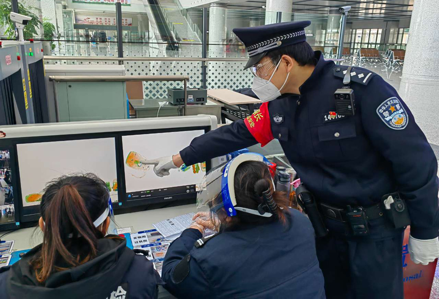 贛州西站安檢口，鐵路執勤民警正在緊盯安檢儀查處旅客攜帶的危險品。韓武攝