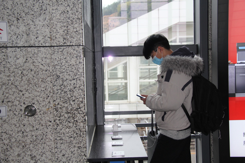 一名旅客在延平站便民充电区免费给手机充电。杨丹平摄
