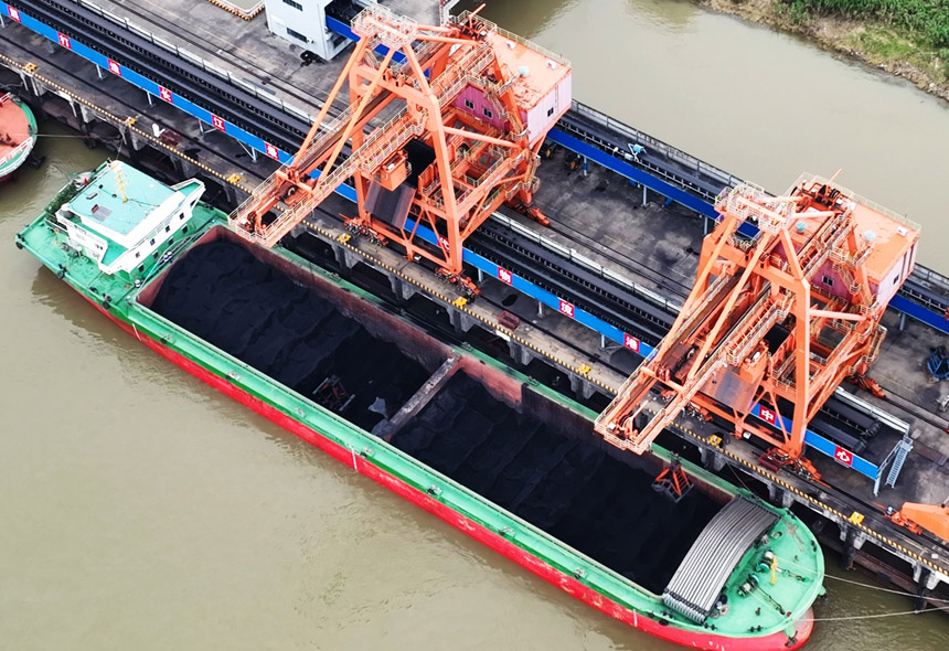 滿載電煤的貨輪停靠在長江碼頭，抓煤機正在緊張卸船。 胡國林攝