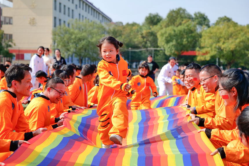 亲子游戏《太空漫步》，中班孩子在彩虹布上奔跑，体验太空漫步的感觉。刘兆春摄