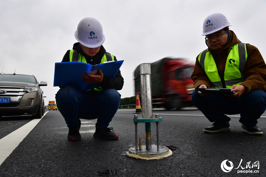 技術人員正在檢測高速公路路面的滲水性能。 人民網記者 時雨攝