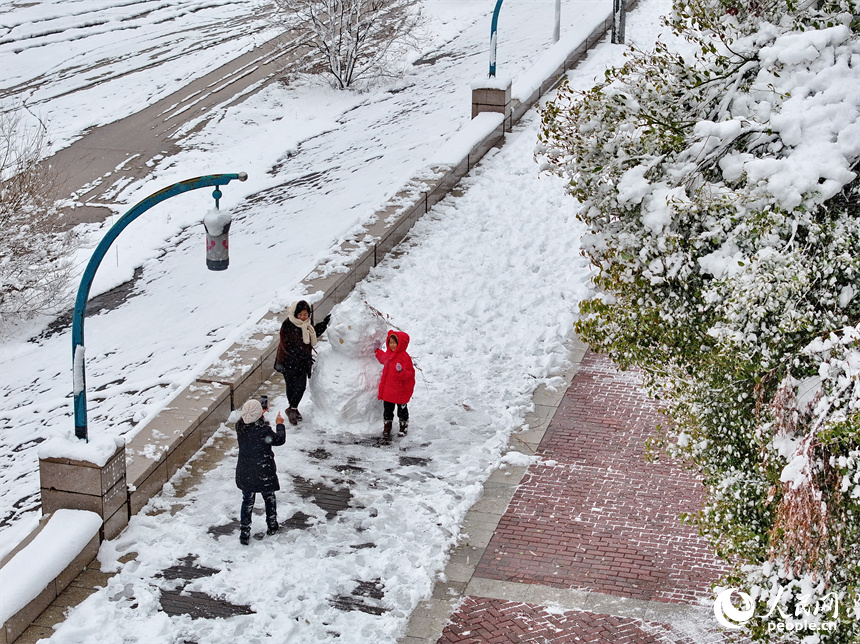 无人机航拍的南昌市红谷滩区银装素裹、白雪皑皑，城市雪景美如画。人民网 朱海鹏摄