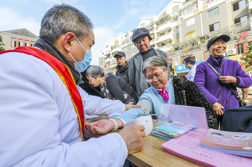 医务人员正在为居民测量血压。谢东摄