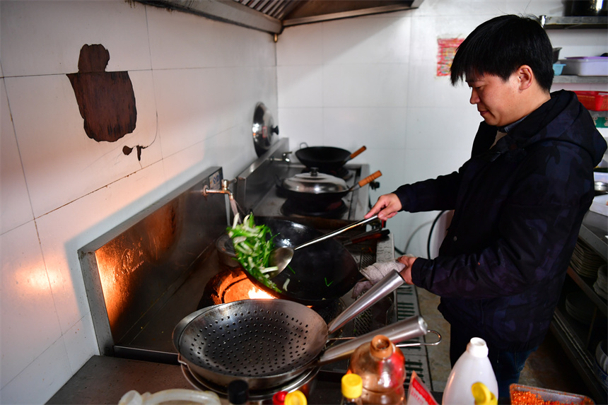 葉延海正在廚房炒菜。 人民網記者 時雨攝