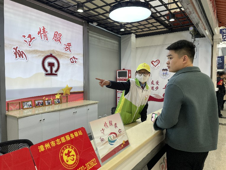 漳州车务段志愿者“青小柠”在服务台为旅客提供咨询服务 陈柯添摄
