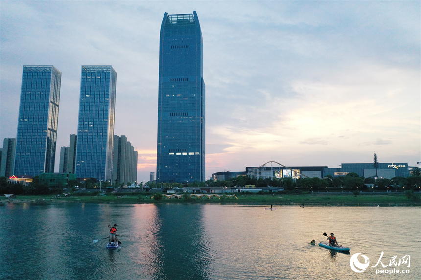 在贛江紅谷灘水域，水上運動愛好者們劃著槳板享受著水上運動帶來的樂趣。人民網記者 時雨攝