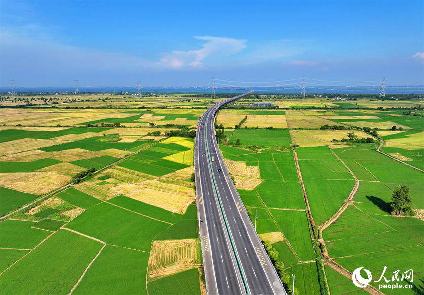 南昌市南昌縣涇口鄉，杭長高速公路上的車輛穿村而過，沿途田園廣袤、碧波萬頃，美景如畫。人民網 朱海鵬攝