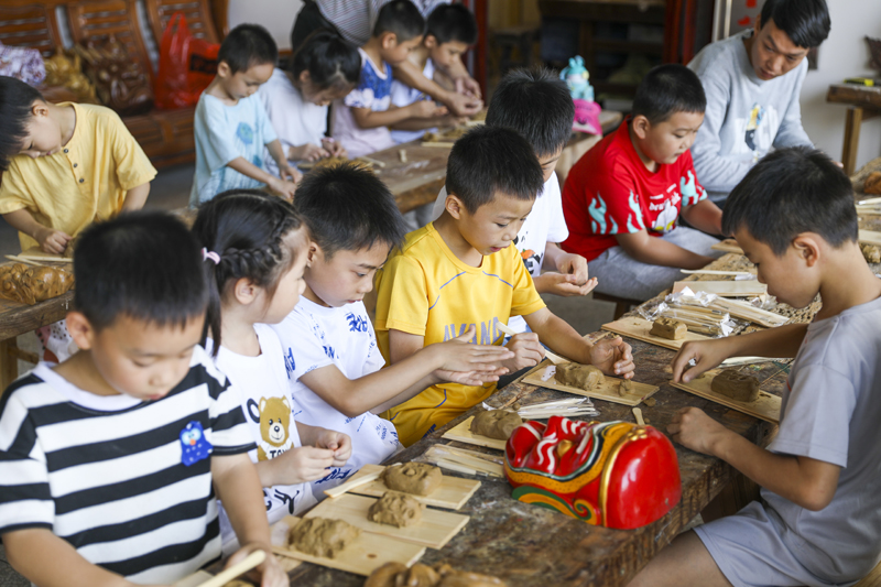 公益暑期托管班组织学生走进傩面具展示馆，学习体验傩面具制作，充实假期生活。谢东摄