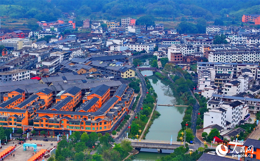 赣州市宁都县小布镇，乡村公路旁的农家房屋整齐排列，与蜿蜒河流、连绵山峦相映成景。人民网 朱海鹏摄