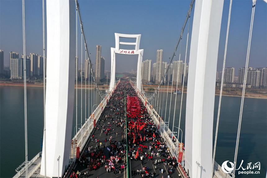 “健步洪州大橋，擁抱幸福生活”南昌市第十三屆迎新健步行活動啟幕。圖為市民和游客行走在洪州大橋上。人民網記者 時雨攝