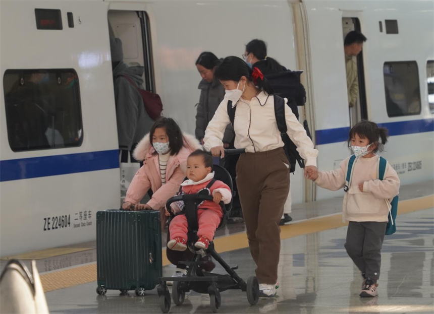 1月22日，南昌西站站台上，一位母親帶著孩子踏上歸家的旅程。王焱茹攝