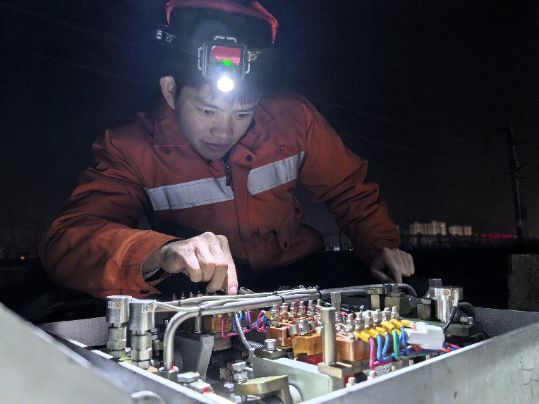 工作人員檢查核對轉轍機缺口。劉觀仁攝