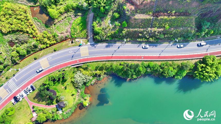 赣州市上犹县东山镇，车辆在环湖公路行驶，沿线水清岸绿景美春意浓。人民网 朱海鹏摄