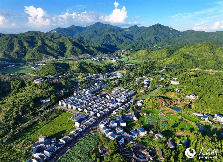 赣州市石城县琴江镇大畲村，错落分布的农房与莲田、山峦、旅游公路相映成景，构成一幅绿意盎然、和美宜居的山乡画卷。人民网 朱海鹏摄