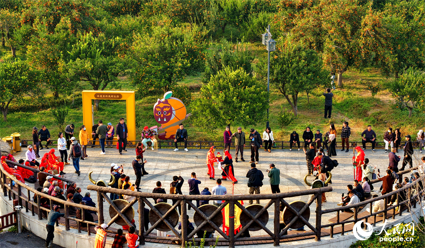 撫州市南豐縣琴城鎮水南村貢橘苑，村民和游客在觀看南豐儺舞表演。人民網記者 朱海鵬攝