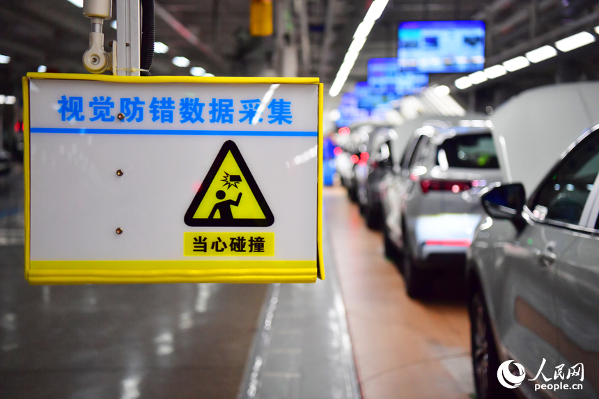 准備交付的新車進行人工智能視覺防錯數據採集，智能攝像頭記錄車身數據上傳網絡終端進行技術比對。人民網記者 毛思遠攝