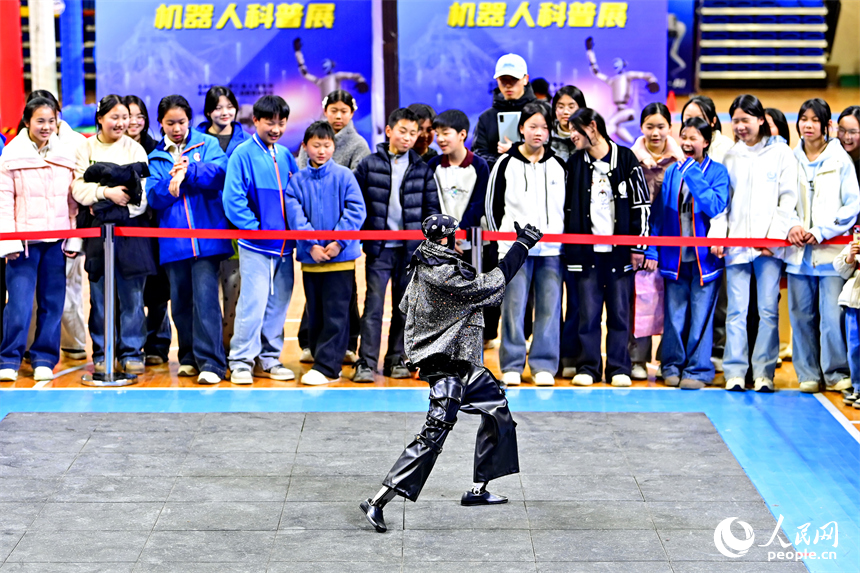 青少年学生和市民在机器人科普展现场体验机器狗、群舞机器人、下棋机器人。人民网记者 朱海鹏摄