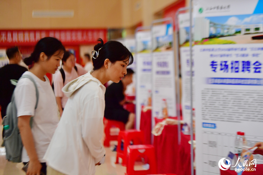 江西中医药大学专场招聘会上，毕业生正在查看招聘启事。人民网记者 时雨摄