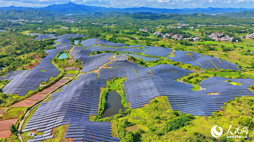 信丰县正平镇的农光互补光伏发电基地，鳞次栉比的太阳能光伏板与绵延青山、广袤沃野相映成景，美不胜收。人民网记者 朱海鹏摄